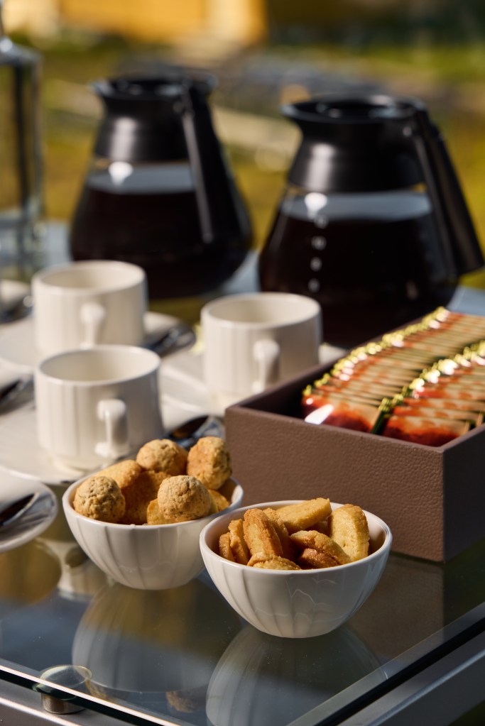 A beautifully arranged breakfast spread featuring fresh coffee, assorted pastries, and delightful treats to enjoy